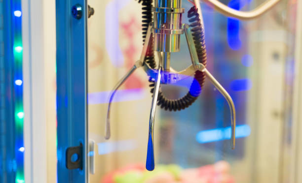istock Mechanical claw game machine. Close-up view. 1199296335