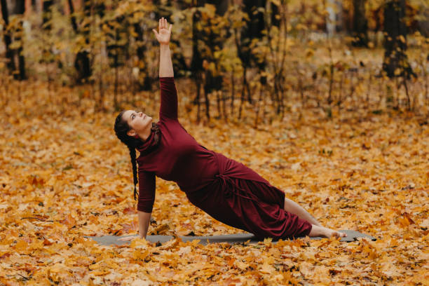 istock Curvy girl doing yoga in nature. 1199296594