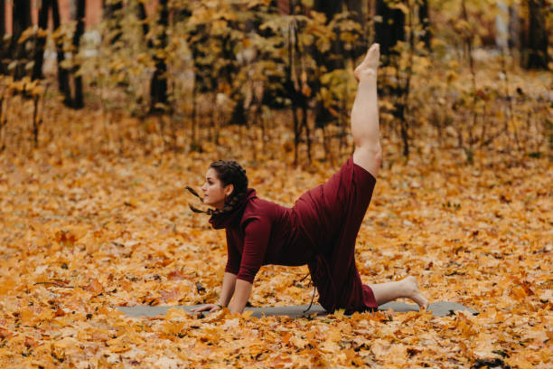 istock Curvy girl doing yoga in nature. 1199296595