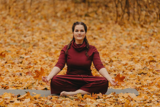 istock Curvy girl doing yoga in nature. 1199296597