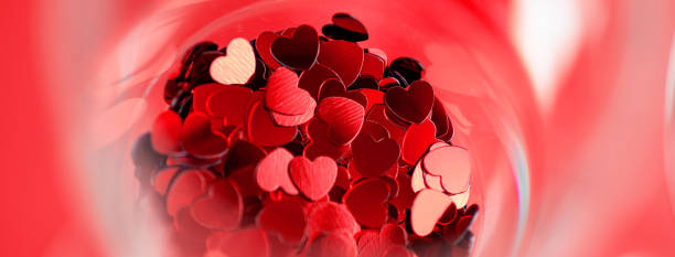Red hearts are scattered in a glass. Valentine's Day concept