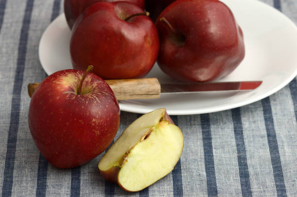 istock Delicious Apples in plate with knife on striped tablecloth 1199299063