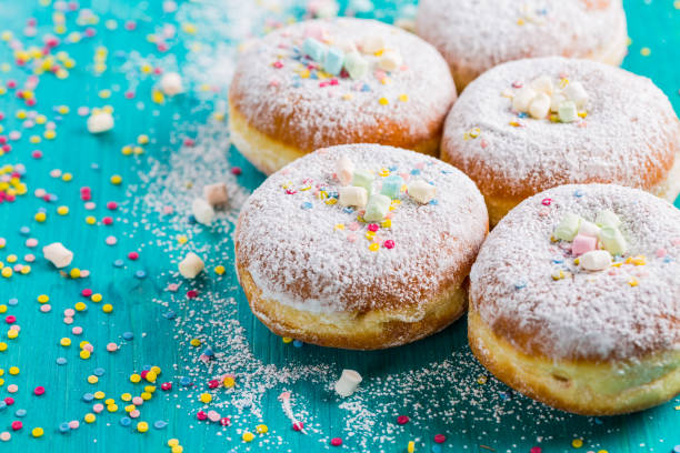 istock Carnival powdered sugar raised donuts - German Berliner donuts 1199301738