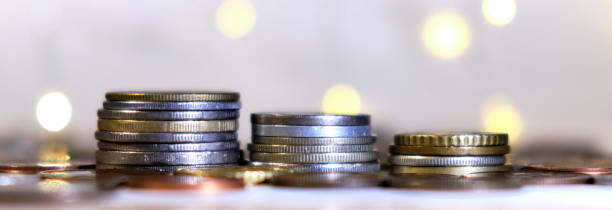 istock Coins stacked in stacks on a colored background with a side 1199304138