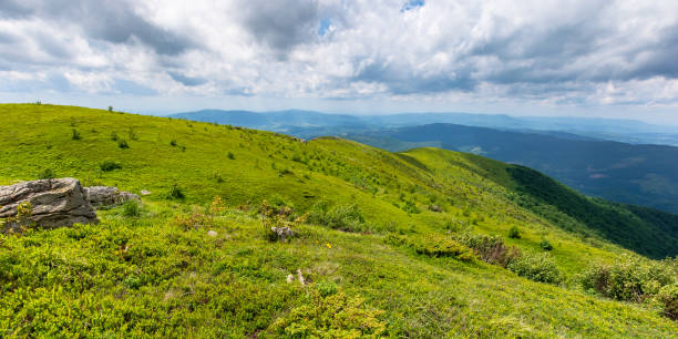 istock green meadows in mountains with clouds on the sky 1199305200