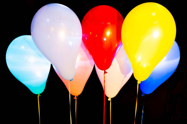 istock Colorful balloons illuminated with LED against dark background 1199306006