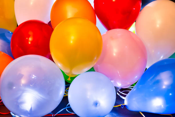 istock Colorful balloons illuminated with LED against dark background 1199306134