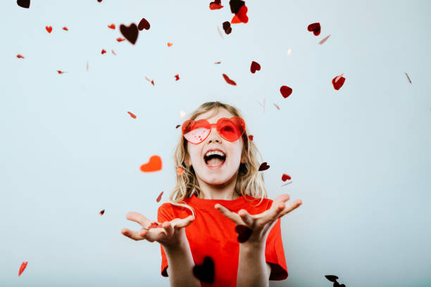 cute valentines day girl wearing heart sunglasses - valentines day heart shape love child imagens e fotografias de stock