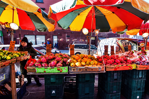 China Town, New York, NY, USA - November 30, 2019. Fresh vegetables and fruits at outdoor market in Chinatown, New York.