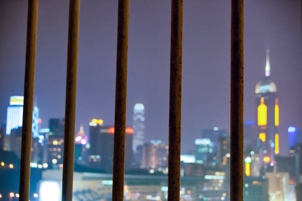 Hong Kong skyline seen in distance through bars