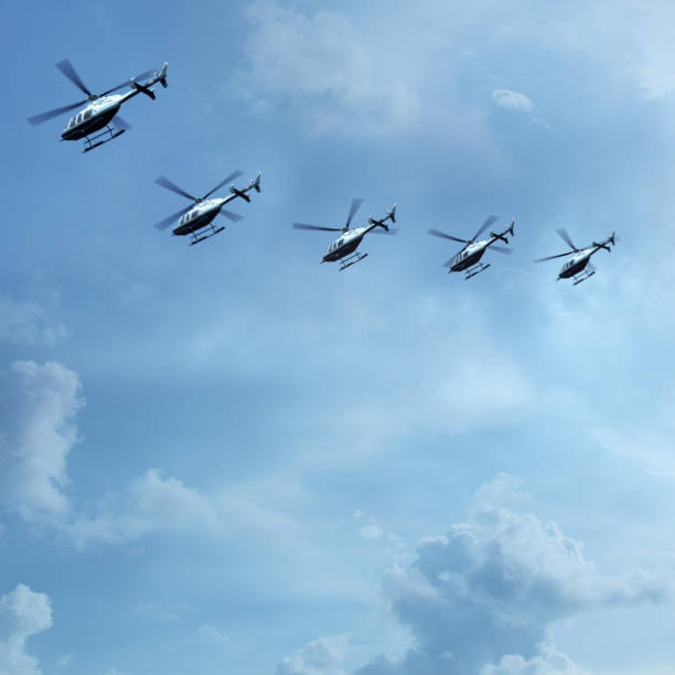 group of helicopters flying in cloudy sky