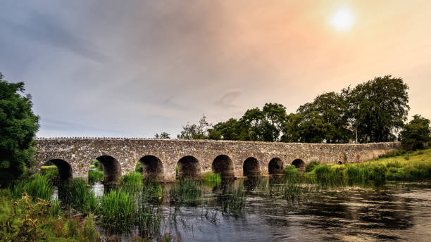 istock Old 12th century stone arch bridge over a river. Count Meath, Ireland 1199309032