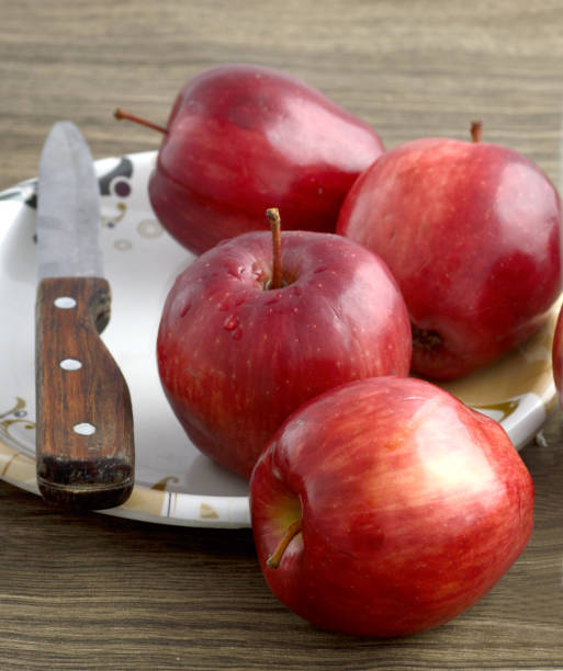 istock Ripe red apples on wooden background 1199309990