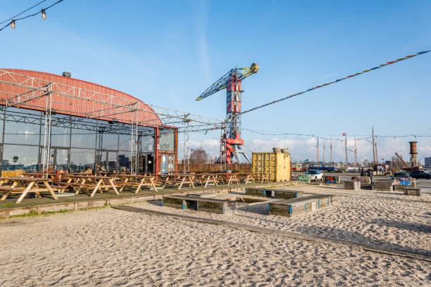 holland, januari 2020, amsterdam, colorfull scenes at the ndsm werf with its cranes and grafiti in the north of amsterdam near the ij in the river amstel - editorial land vehicle construction equipment built structure imagens e fotografias de stock