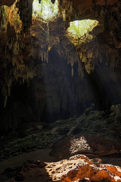 istock Beautiful cave with light rays come inside through holes into the rock. 1199310575