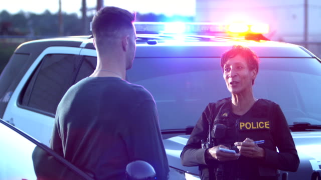 Policewoman talking to a young man