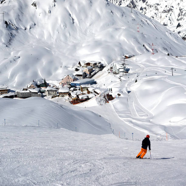 Male extreme skier riding backcountry in the deep snow on a sunny day in St. Anton, Austria