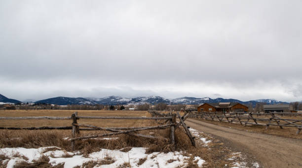 istock Rural country road with rustic fence 1199322972