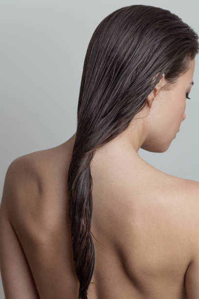 Portrait of woman Portrait of woman with wet hair rear view  focus on hair wet hair stock pictures, royalty-free photos & images