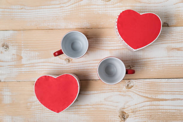 istock Two empty cups and heart shaped boxes. Date, Valentine's Day. Top view 1199328555