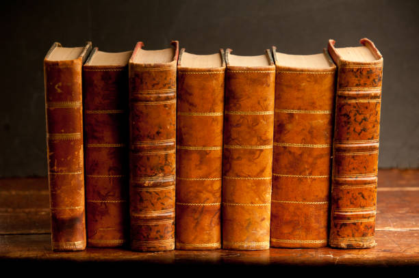 istock stack of blue books on old wooden shelf with dark background 1199331271