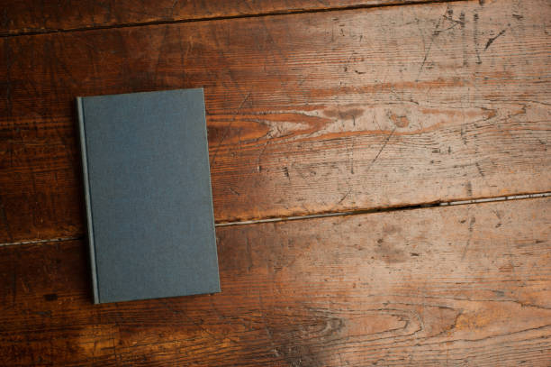 istock blue book on old wooden table 1199331305