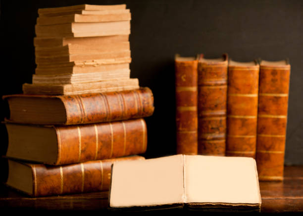 istock old books on wooden desk, with open book 1199331319