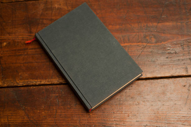 istock blue book on old wooden table 1199331356