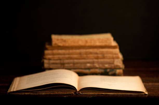 istock old books on wooden desk, with open book 1199331376