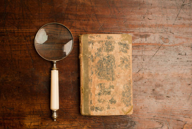 istock retro old book with optical magnifying glass on old wooden table 1199331407