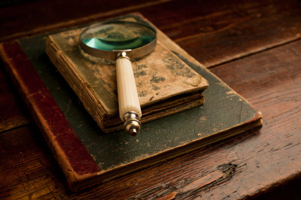 istock retro old books with optical magnifying glass on old wooden table 1199331438