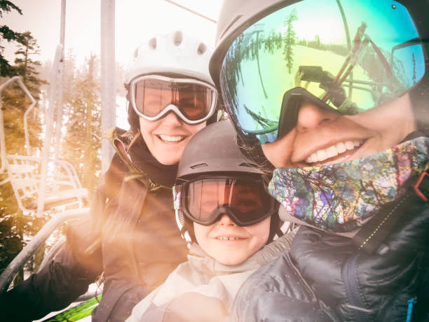 a young mom couple take their child skiing in truckee, california - family skiing ski vacations imagens e fotografias de stock