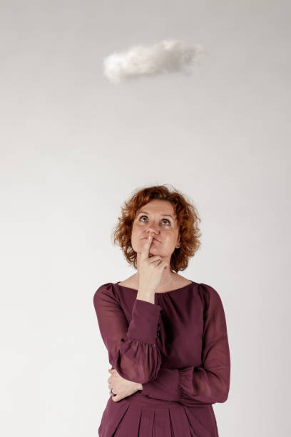 istock Red-haired woman and small cloud. 1199333032
