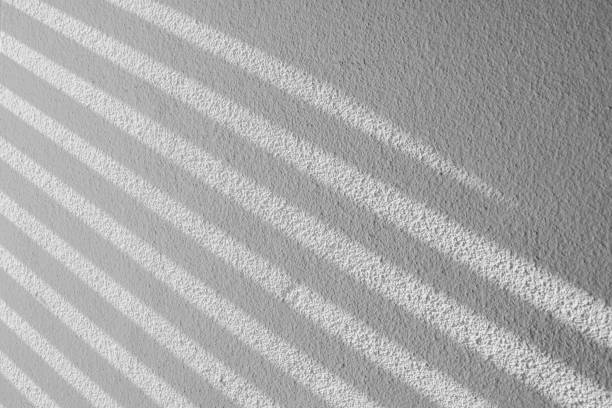 istock shadow batten of lath and morning light on white concrete wall 1199335160