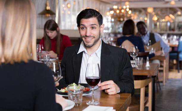 istock Happy man with girlfriend in restaurant 1199336306