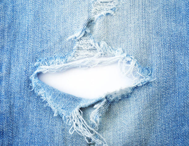 Ripped Torn Pattern Of Light Blue Denim Jeans Stock Photo
