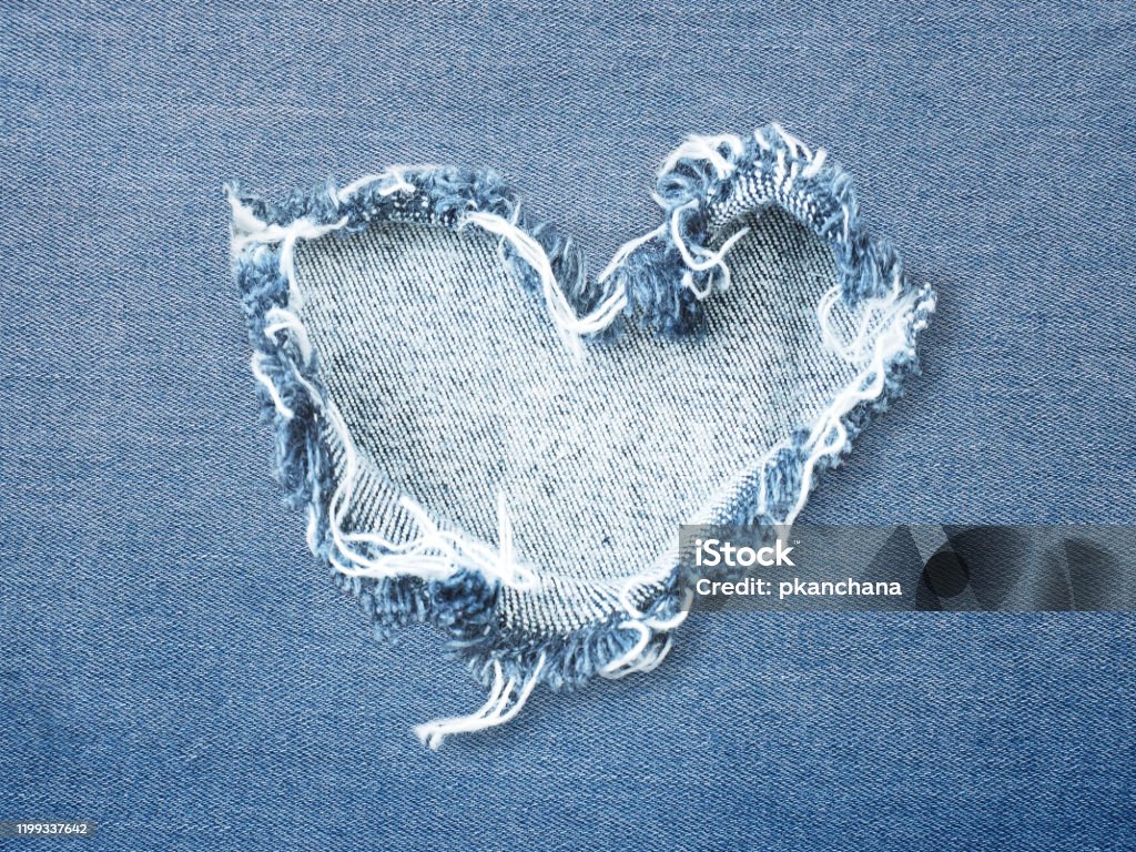 Heart shape ripped jean Heart shape ripped jean denim texture for Valentine's card background. Love concept. Denim Stock Photo