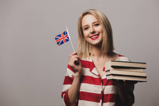 istock beatiful girl holds British flag and books 1199337733