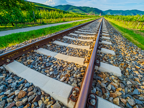 View of a rail line leading to the town of Weissenkirchen and surrounding vineyards in Austria