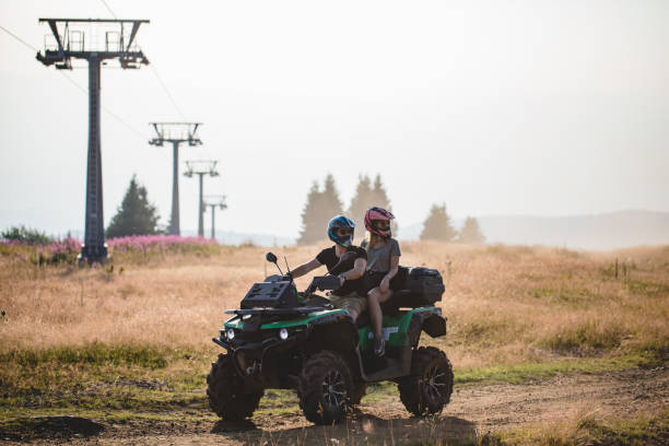 istock Young happy couple having fun while driving on quad bike 1199340016