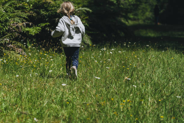 istock Child in nature green grass 1199342949