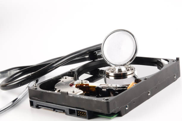 istock RECOVERY AND REPAIR TECHNOLOGY CONCEPT: Hard Disk Drive (HDD) with stethoscope isolated on white. 1199343555