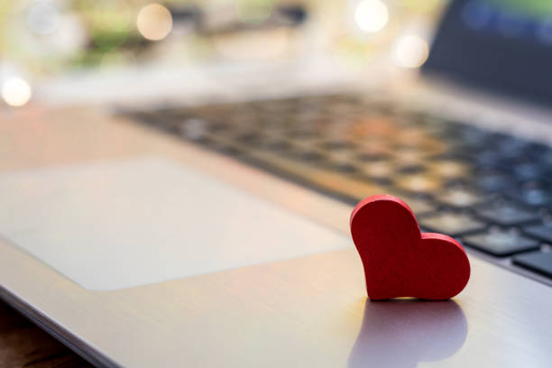 istock Online Dating concept with laptop red heart shape 1199346944