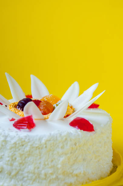 istock Festive white cake decorated with jelly on a yellow background 1199351453