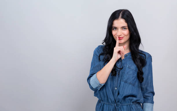 istock Young woman making a quiet gesture 1199352724