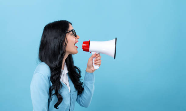 istock Young woman with a megaphone 1199352797