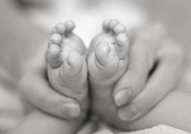 istock Mother gently hold baby legs in hand 119935373