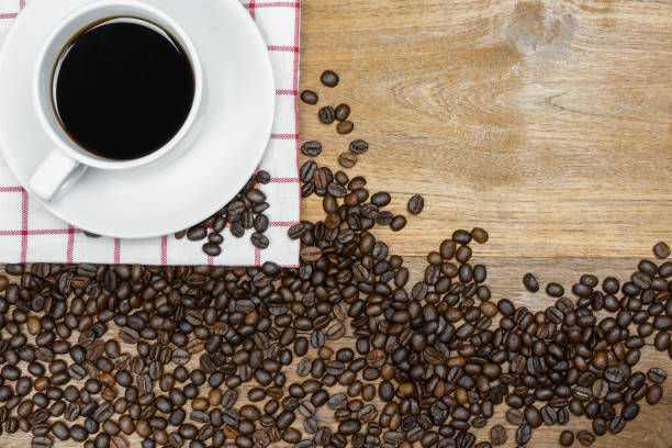 istock Hot coffee with coffee beans on wooden background 1199353884