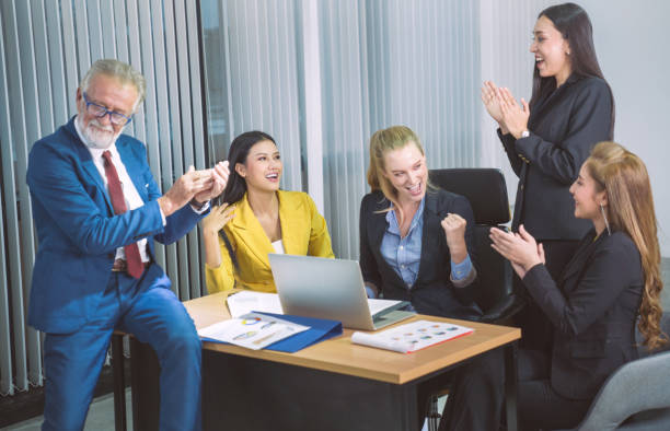 istock Group of young multiethnic diverse people gesture hand high five, laughing and smiling together in brainstorm meeting at office. Casual business with startup teamwork community celebration concept 1199354672