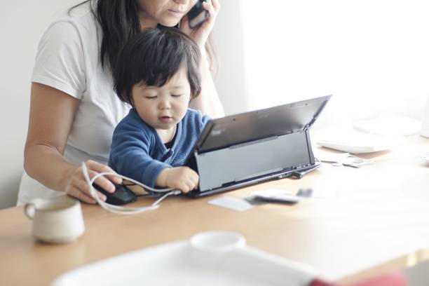 istock Mother working at home with her son 1199358786